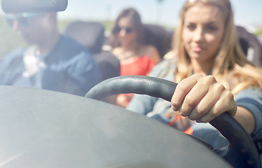 Image showing happy friends driving in convertible car