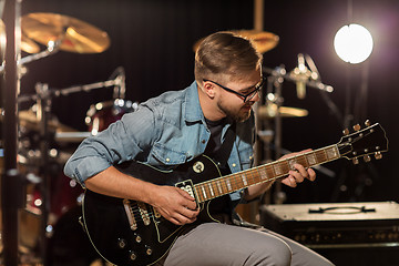 Image showing man playing guitar at studio rehearsal