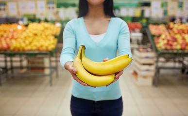 Image showing woman with bananas at grocery store