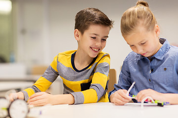 Image showing happy children building robots at robotics school