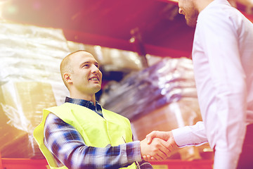 Image showing worker and businessmen with clipboard at warehouse