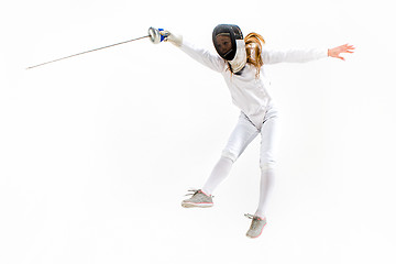 Image showing Man wearing fencing suit practicing with sword against gray