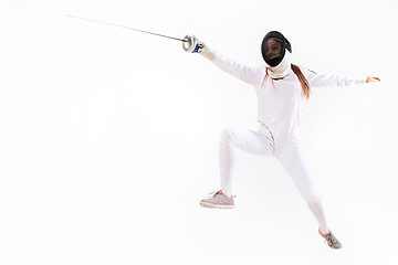 Image showing Man wearing fencing suit practicing with sword against gray