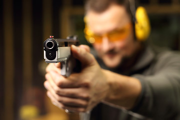 Image showing Shooting a gun at shooting range