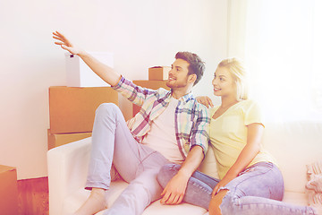 Image showing couple with boxes moving to new home and dreaming