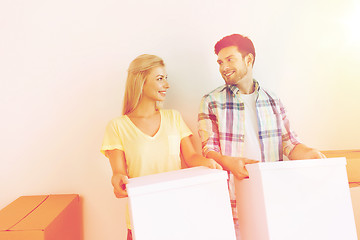 Image showing smiling couple with big boxes moving to new home