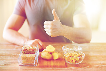 Image showing close up of male hands with carbohydrate food