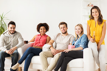 Image showing happy friends with popcorn and beer at home