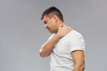 Image showing unhappy man suffering from neck pain