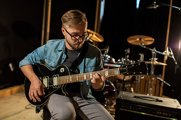 Image showing man playing guitar at studio rehearsal