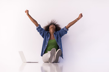 Image showing african american woman sitting on floor with laptop