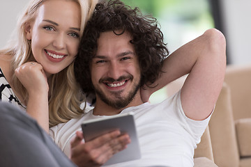 Image showing couple relaxing at  home with tablet computers