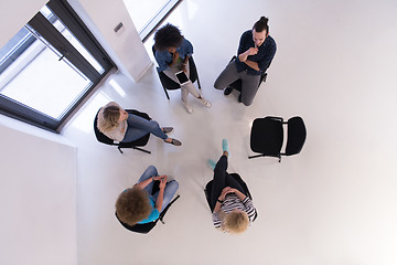 Image showing Multiethnic startup business team on meeting  top view