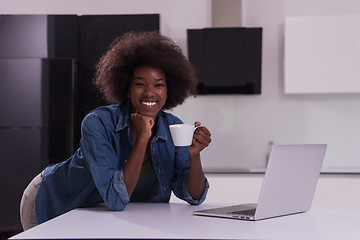 Image showing smiling black woman in modern kitchen