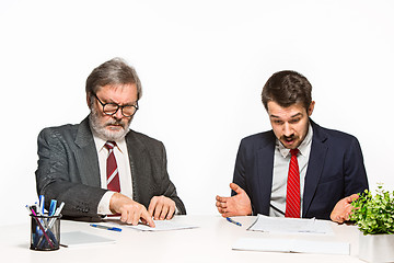 Image showing The two colleagues working together at office on white background.