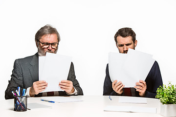 Image showing The two colleagues working together at office on white background.