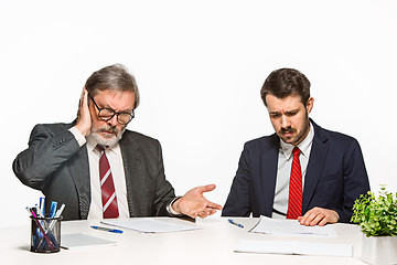 Image showing The two colleagues working together at office on white background.