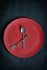 Image showing Clock with red plate, spoon and fork