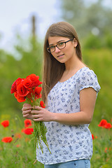 Image showing Young girl in the poppy field
