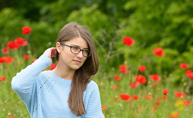 Image showing Young girl in the poppy field