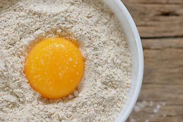 Image showing Flour and eggs ready for mixing 