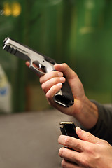 Image showing Shooting a gun at a shooting range.