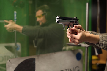 Image showing The man at the shooting range. Science use of firearms.