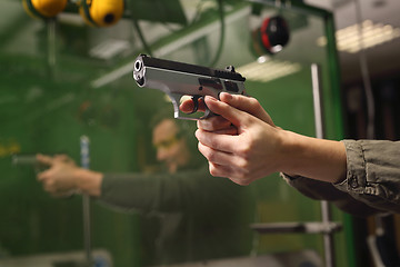 Image showing Shooting a gun at shooting range