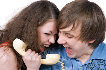 Image showing The young couple with old phone. Funny picture. Isolated 2