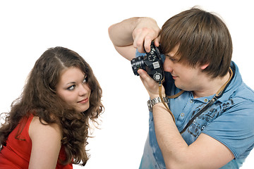 Image showing Photographer taking pictures of the young woman. isolated