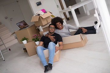 Image showing African American couple  playing with packing material