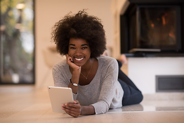 Image showing black women used tablet computer on the floor