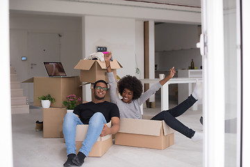 Image showing African American couple  playing with packing material