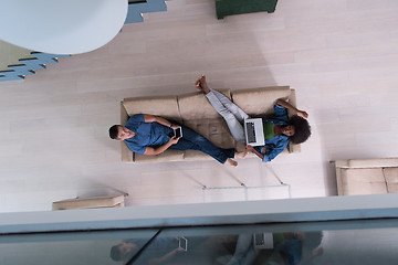 Image showing young multiethnic couple relaxes in the living room top view