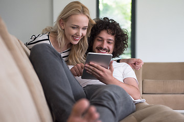 Image showing couple relaxing at  home with tablet computers