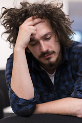 Image showing A student sits alone  in a classroom