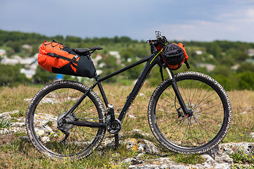 Image showing Bicycle with orange bags for travel