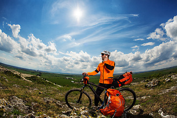 Image showing Young Male Cyclist Talking On Cell Phone