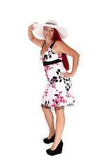 Image showing Red haired woman standing with hat.