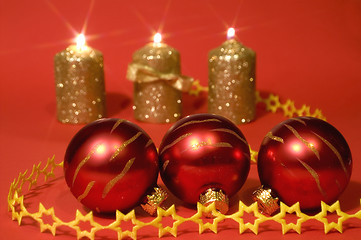 Image showing Gold candles and red glass balls