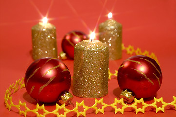 Image showing Gold candles and red glass balls