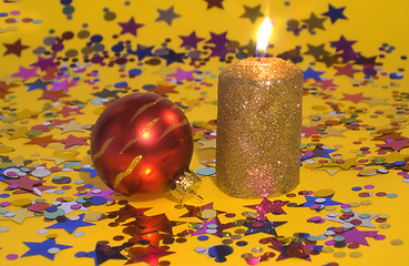 Image showing Gold candle and red glass ball