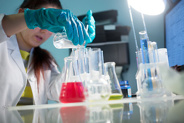 Image showing Young woman carries chemical reactions