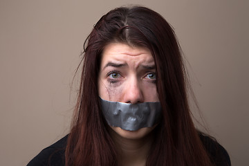 Image showing Frightened woman hostage with tape