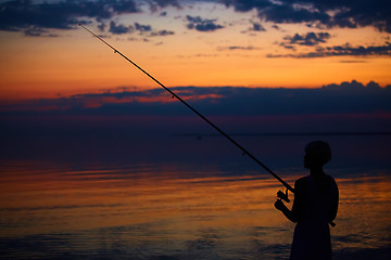 Image showing Fishing Silhouette on dramatic sky and sea