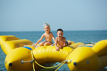 Image showing two happy kids playing on the boat at summer day