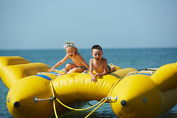 Image showing two happy kids playing on the boat at summer day