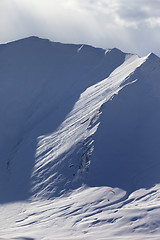 Image showing Speed riding in snow mountains at sun evening