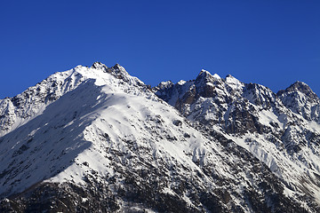 Image showing Snowy rocks and blue clear sky at nice winter day