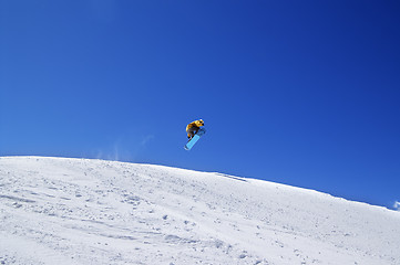 Image showing Snowboarder jump in terrain park at ski resort on sun day